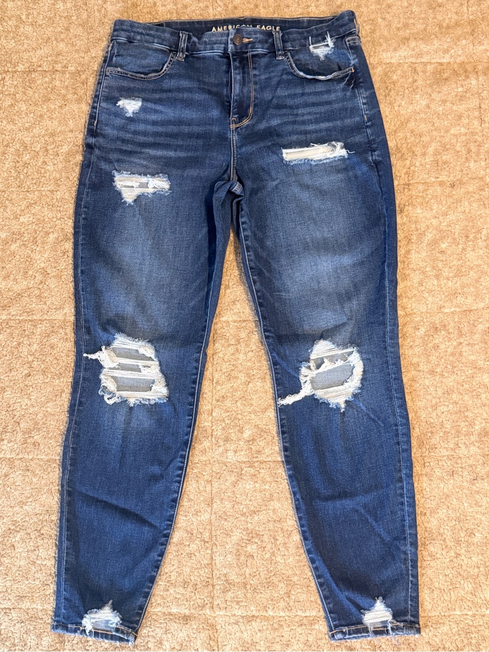 American Eagle Dark Blue Ripped Curvy High Rise Jegging.